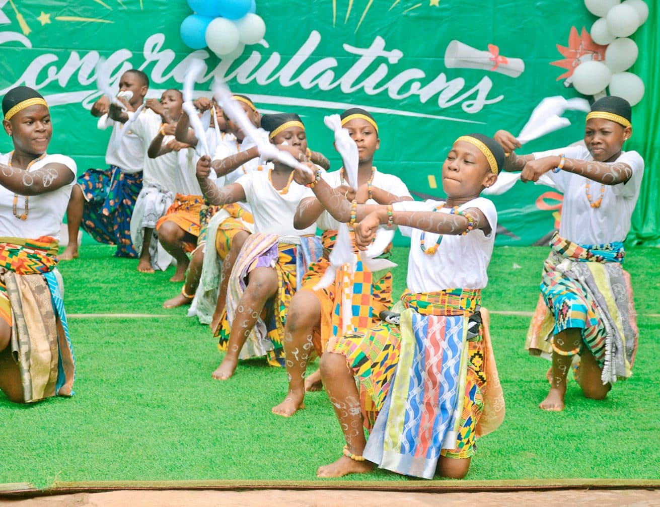 Pupils performing a traditional Ghanaian cultural dance in kente