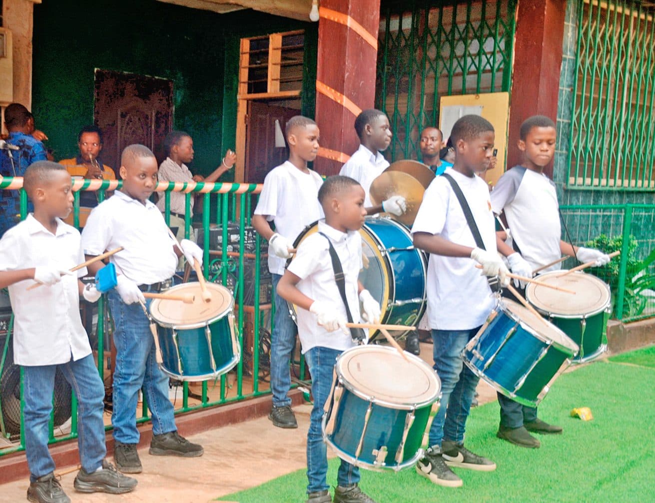 The Be-Light drumming corps performing in the school courtyard